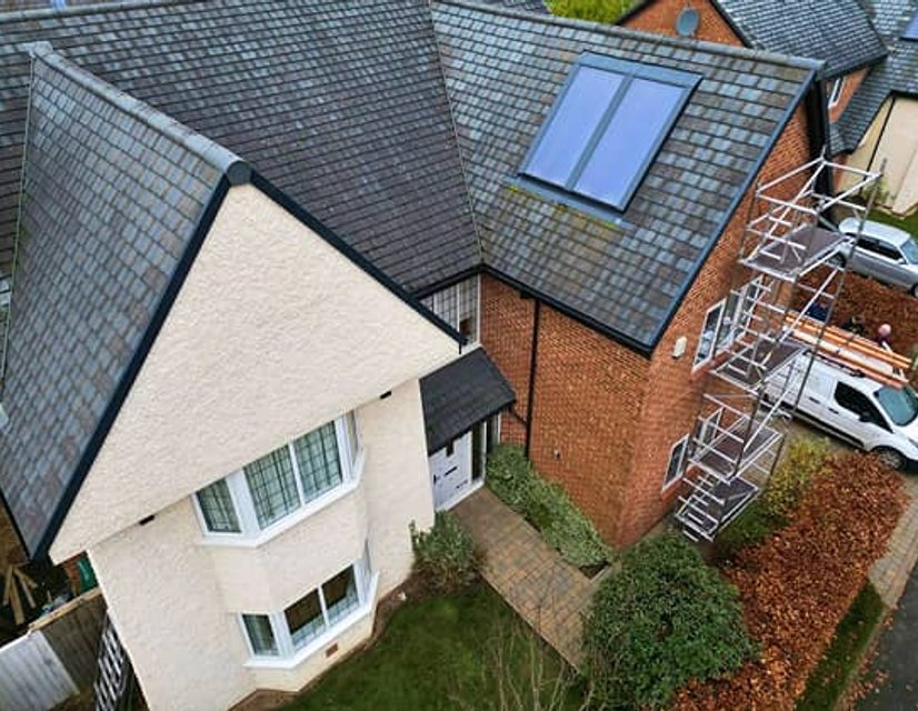 Aerial view of slate roof and scaffolding beside house
